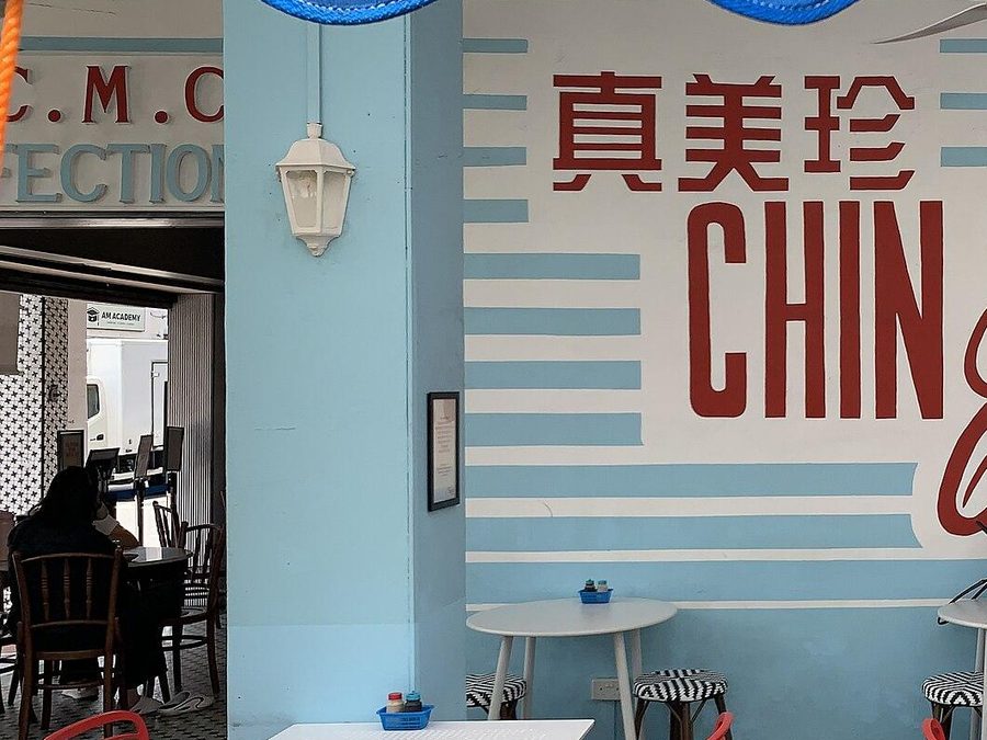 Inside the Chin Mee Chin kopitiam in Katong, marble-top tables and red chairs.