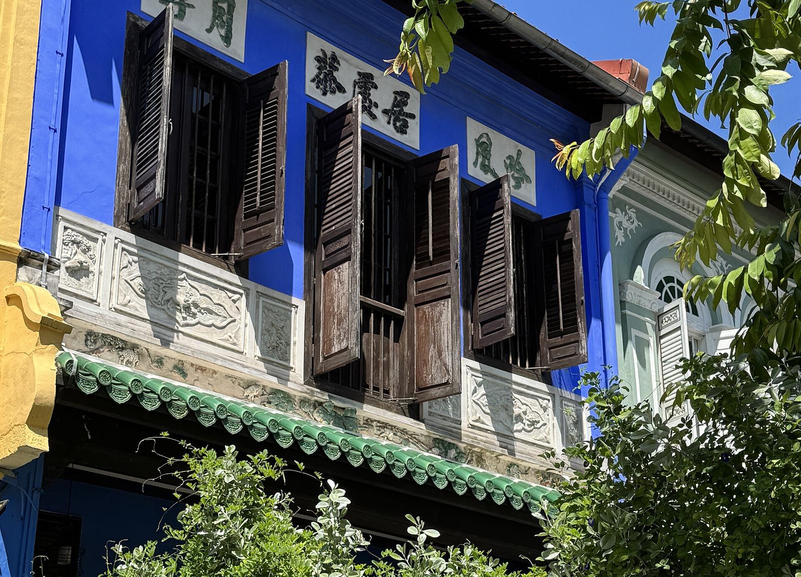 A shophouse on Neil Road, with a dark wooden door.